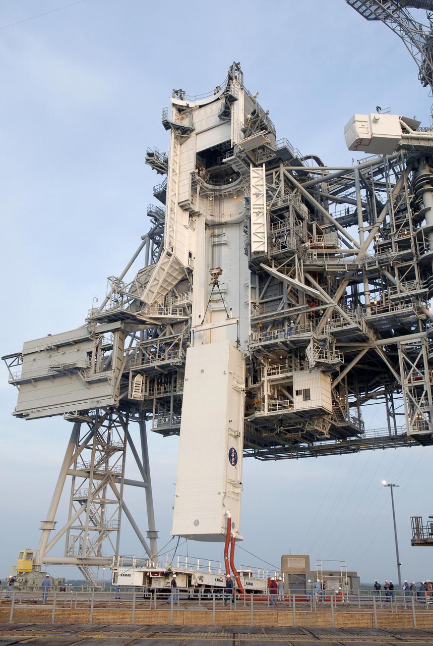 KENNEDY SPACE CENTER, FLA. --   The payload canister is lifted off its transporter up to the payload changeout room.  Inside the canister are the S5 truss, SPACEHAB module and external stowage platform 3, the payload for mission STS-118.  The red umbilical lines are still attached.  The payloads will be transferred inside the changeout room to wait for Space Shuttle Endeavour to arrive at the pad.  The changeout room is the enclosed, environmentally controlled portion of the rotating service structure that supports cargo delivery to the pad and subsequent vertical installation into the orbiter payload bay.  The mission will be Endeavour's first flight in more than four years. The shuttle has undergone extensive modifications, including the addition of safety upgrades already added to shuttles Discovery and Atlantis. Endeavour also features new hardware, such as the Station-to-Shuttle Power Transfer System that will allow the docked shuttle to draw electrical power from the station and extend its visits to the orbiting lab.  Space Shuttle Endeavour is targeted for launch on Aug. 7 from Launch Pad 39A.   Photo credit: NASA_Kim Shiflett