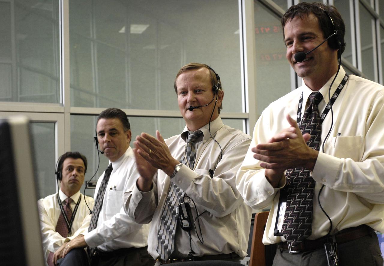In the firing room of the Kennedy Space Center in Florida, NASA Shuttle Launch Director Michael Leinbach (2nd from right) and launch managers watch the 11:38 a.m. EDT launch of Space Shuttle Discovery. Discovery launched Oct. 23 on a 14-day construction mission to the International Space Station. Photo credit: "NASA/Bill Ingalls"