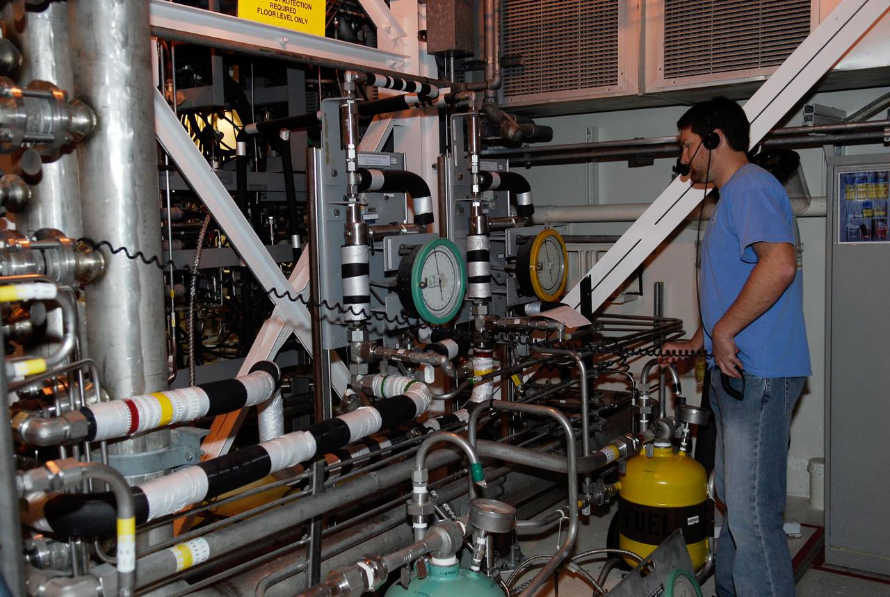 KENNEDY SPACE CENTER, FLA. -- In the hypergolic maintenance facility at NASA's Kennedy Space Center, a technician monitors equipment during testing of the Ares I-X Roll Control System, or RoCS. The RoCS Servicing Simulation Test is to gather data that will be used to help certify the ground support equipment design and validate the servicing requirements and processes. The RoCS is part of the Interstage structure, the lowest axial segment of the Upper Stage Simulator. In an effort to reduce costs and meet the schedule, most of the ground support equipment that will be used for the RoCS servicing is of space shuttle heritage. This high-fidelity servicing simulation will provide confidence that servicing requirements can be met with the heritage system. At the same time, the test will gather process data that will be used to modify or refine the equipment and processes to be used for the actual flight element. Photo credit: NASA_Kim Shiflett