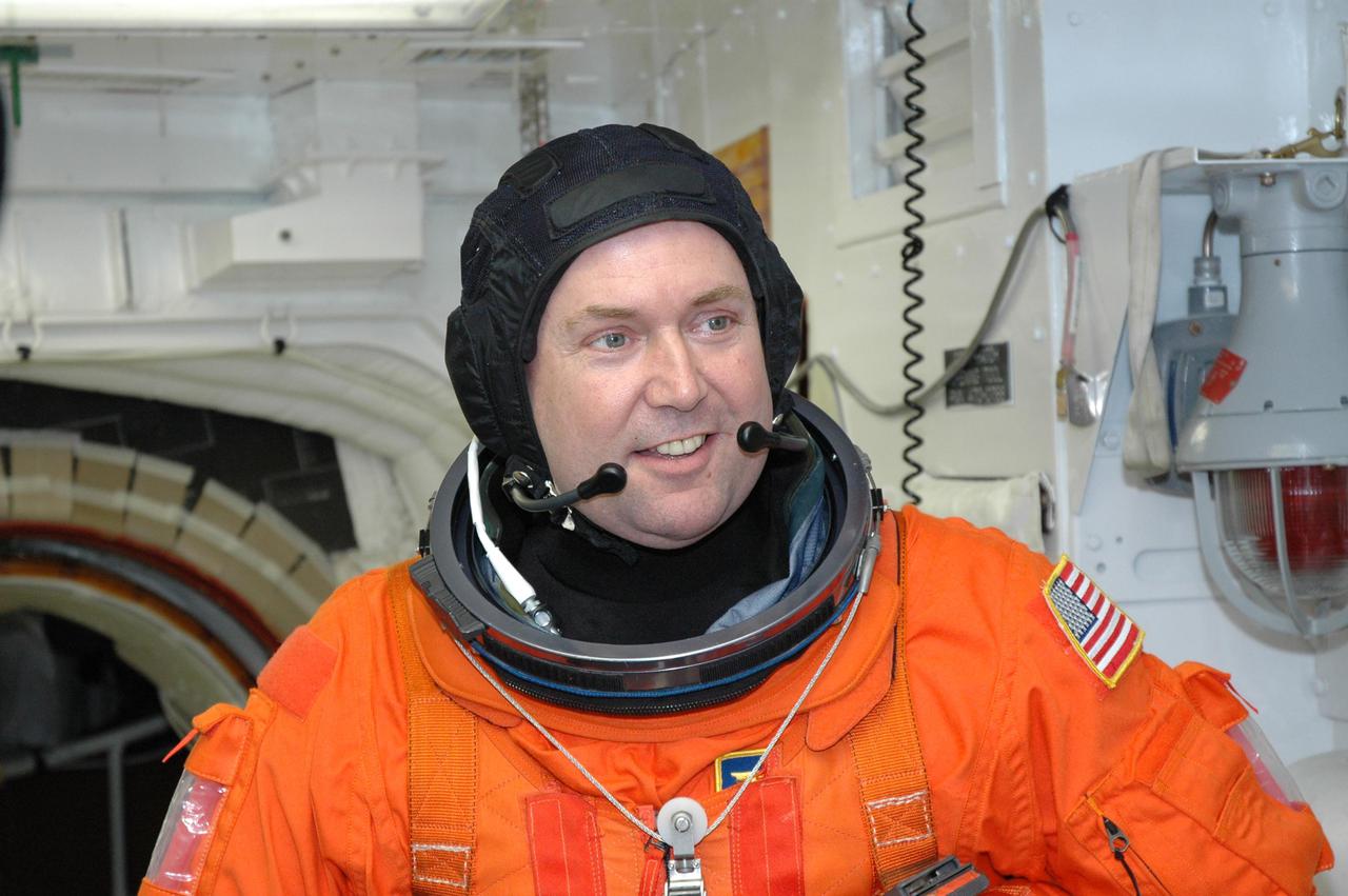 KENNEDY SPACE CENTER, FLA. --  In the White Room on NASA Kennedy Space Center's Launch Pad 39A, STS-123 Mission Specialist Mike Foreman is preparing to enter space shuttle Endeavour.  He and the other STS-123 crew members are getting ready for the simulated launch countdown, which is the culmination of the terminal countdown demonstration test, or TCDT.  The TCDT provides astronauts and ground crews with an opportunity to participate in various countdown activities, including equipment familiarization and emergency egress training. Endeavour is targeted to launch at 2:28 a.m. EDT March 11 on the 16-day STS-123 mission to the International Space Station.  Endeavour and its crew will deliver the first section of the Japan Aerospace Exploration Agency's Kibo laboratory and the Canadian Space Agency's two-armed robotic system, Dextre.   Photo credit: NASA_Jim Grossmann