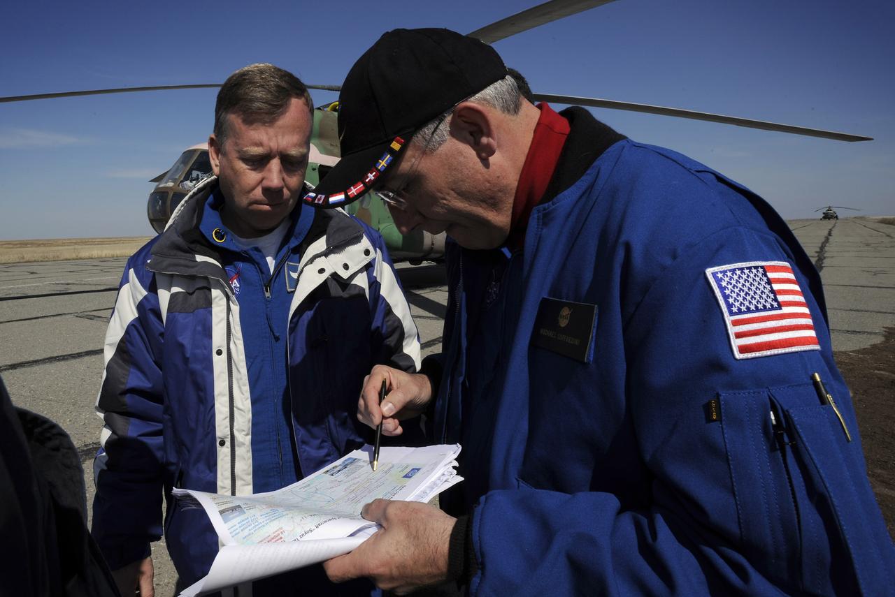 Steve Lindsey, Chief of NASA's Astronaut office, left, and Michael Sufferdini, International Station Program Manager, examine a map of central Kazakhstan as they received information at the Arkalyk airport April 19, 2008 on the landing of the Expedition 16 crew in the Soyuz TMA-11 capsule. The Soyuz made a ballistic landing, touching down more then 400 kilometers short of the intended target, but the crew reported by satellite phone to recovery forces that they were in good shape. Photo Credit: (NASA/Bill Ingalls)
