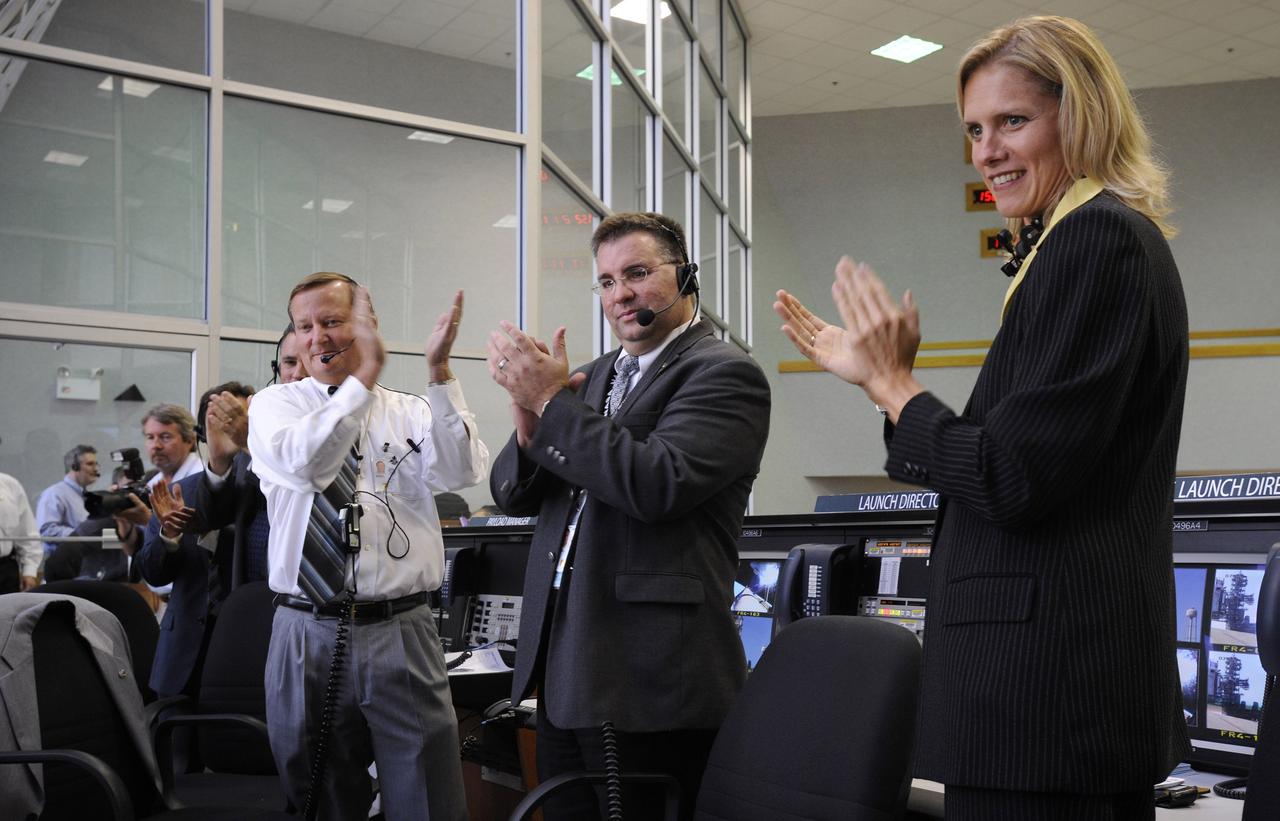 NASA Shuttle Launch Director Michael Leinbach, left, STS-124 Assistant Launch Director Ed Mango, center, and Flow Director for Space Shuttle Discovery Stephanie Stilson clap in the the Launch Control Center after the main engine cut off and successful launch of the Space Shuttle Discovery (STS-124) Saturday, May 31, 2008, at the Kennedy Space Center in Cape Canaveral, Fla. The Shuttle lifted off from launch pad 39A at 5:02 p.m. EDT. Photo Credit: (NASA/Bill Ingalls)