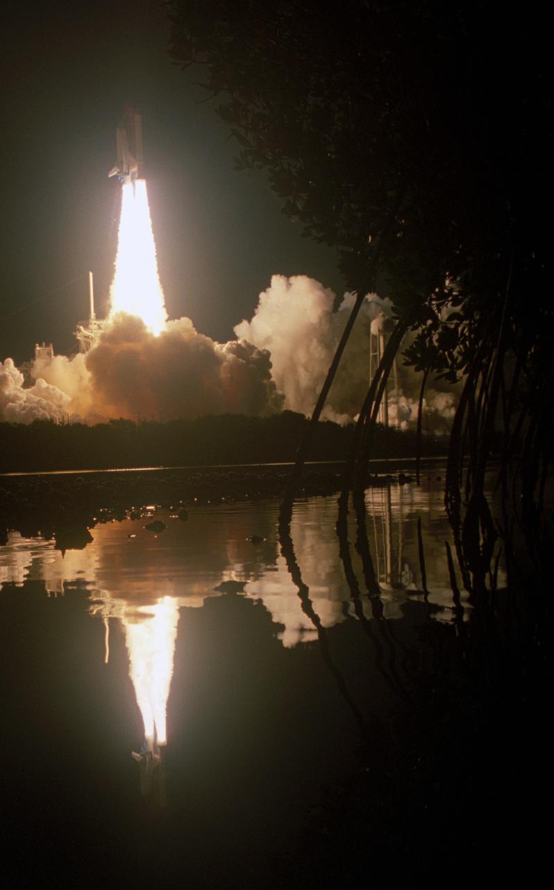 KENNEDY SPACE CENTER, FLA. -- The water near Launch Pad 39A at NASA's Kennedy Space Center provides a mirror image of space shuttle Endeavour's launch on the STS-123 mission. Liftoff was on time at 2:28 a.m. EDT. Endeavour's crew will make a record-breaking 16-day mission to the International Space Station and deliver the first section of the Japan Aerospace Exploration Agency's Kibo laboratory and the Canadian Space Agency's two-armed robotic system, Dextre. Photo credit: NASA_Sandra Joseph, Tony Gray, Robert Murray