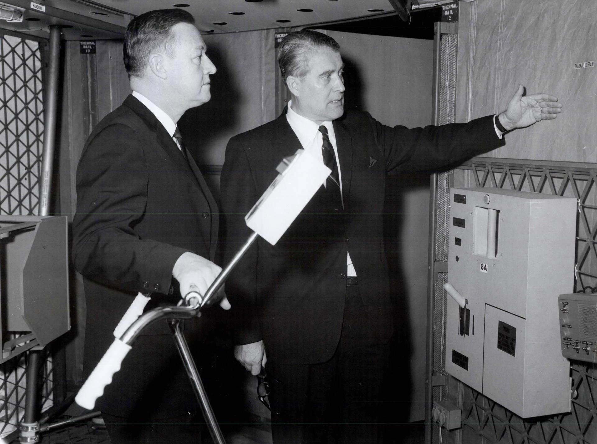 Dr. Wernher von Braun, Director of the Marshall Space Flight Center, explains the purpose of a thermal curtain in the mockup of a Saturn I workshop to U.S. Representative Armistead Seldon of Alabama.