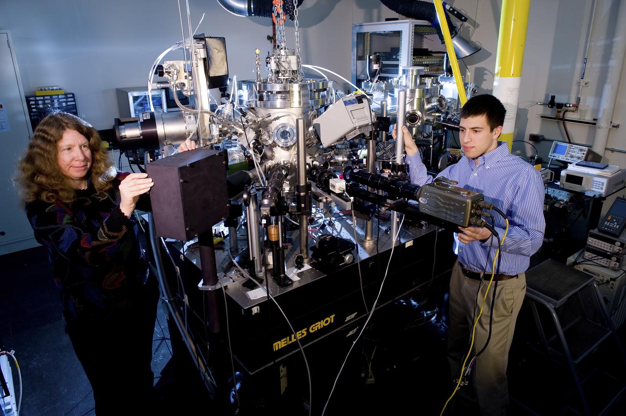 DR. JAN ROGERS, LEFT, AND MATTHEW SHERMAN WITH THE ELECTROSTATIC LEVITATOR