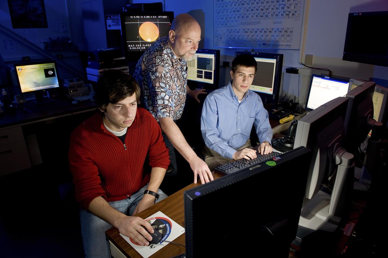 PAUL CHOUFANI, PROFESSOR DOUGLAS MATSON, AND MATTHEW SHERMAN AT THE CONTROLS OUTSIDE OF THE ELECTROSTATIC LEVITATOR.