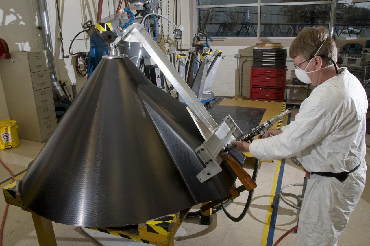 ROBERT CARROLL, A MACHINIST WITH LOCKHEED MARTIN, DRILLS ALIGNMENT HOLES ON THE EXTERNAL TANK COMPOSITE NOSE CONE