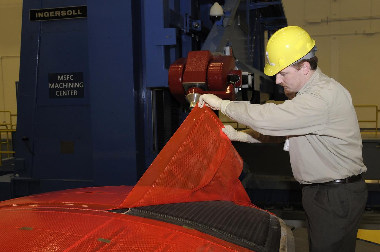 JOHN V. BAUSANO, ICRC, COMPOSITE ENGINEER, CHECKING QUARTER DOME MACHINING VERIFICATION FILM