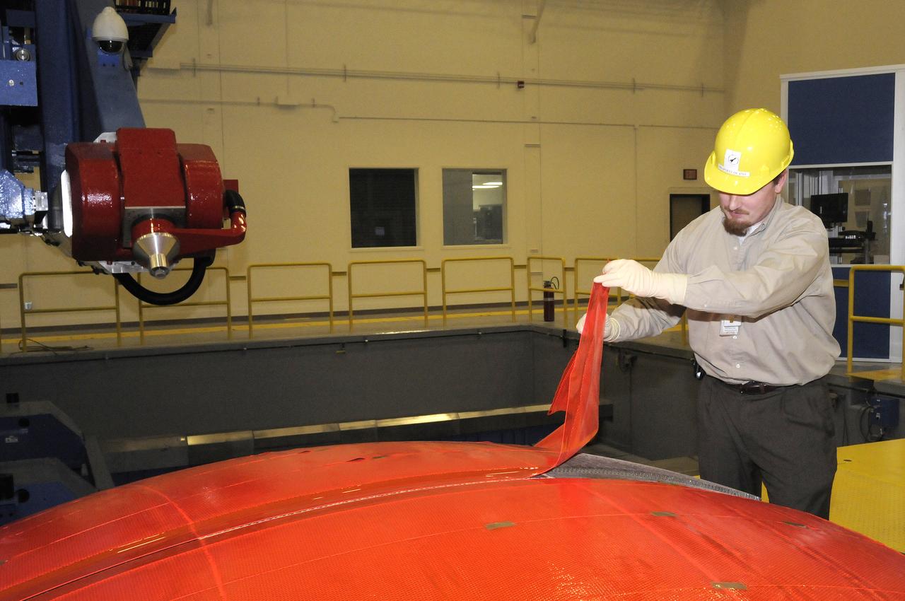 JOHN V. BAUSANO, ICRC, COMPOSITE ENGINEER, CHECKING QUARTER DOME MACHINING VERIFICATION FILM
