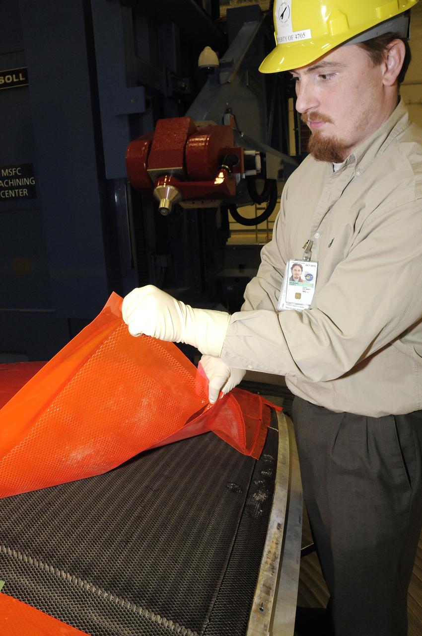JOHN V. BAUSANO, ICRC, COMPOSITE ENGINEER, CHECKING QUARTER DOME MACHINING VERIFICATION FILM.