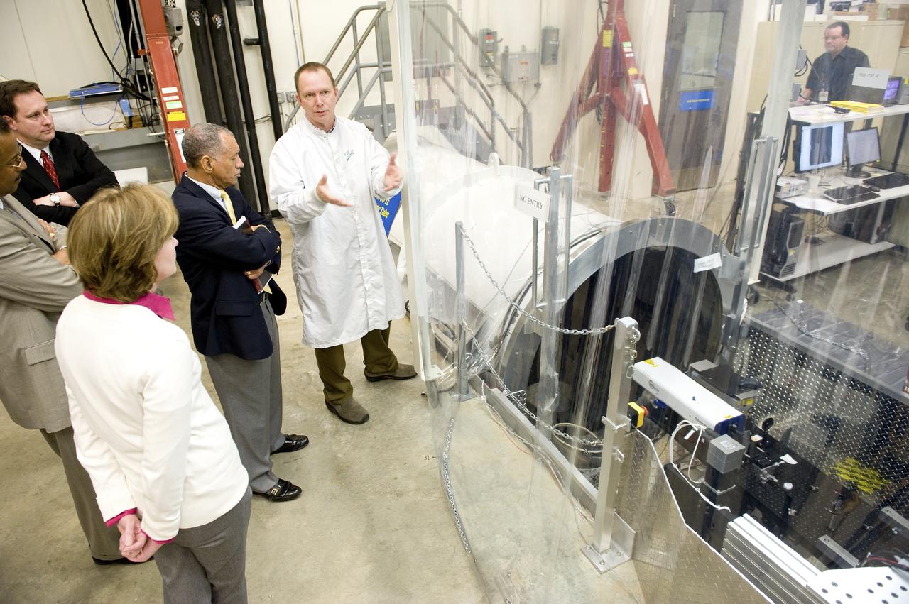 NASA ADMINISTRATOR CHARLES BOLDEN LOOKS ON AS BALL AEROSPACE TECHNOLOGIES CORPORATION PRINCIPLE OPTICAL ENGINEER DAVE CHANEY EXPLAINS HOW THE JAMES WEBB SPACE TELESCOPE MIRROR SEGMENTS ARE TESTED IN MARSHALL'S X-RAY AND CRYOGENIC FACILITY. PICTURED FROM LEFT: HELEN COLE, WEBB TELESCOPE ACTIVITIES PROJECT MANAGER AT MARSHALL; CHARLES SCALES, ASSOCIATE DEPUTY ADMINISTRATOR: ROBERT LIGHTFOOT, CENTER DIRECTOR; CHARLES BOLDEN, NASA ADMINISTRATOR; DAVE CHANEY, BALL OPTICAL ENGINEER.