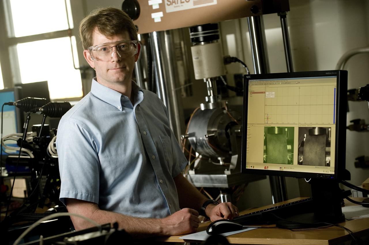 ERIC EARHART (AEROSPACE ENGINEER, ER41 PROPULSION STRUCTURAL & DYNAMICS ANALYSIS BRANCH) DISCUSSES DATA PRODUCED BY A UNIQUE MECHANICAL TEST SETUP THAT MEASURES STRAIN ON A SINGLE SAMPLE, USING TWO DIFFERENT TECHNIQUES AT THE SAME TIME. THE TEST FIXTURE HOLDS A SPECIMEN THAT REPRESENTS A LIQUID OXYGEN (LOX) BEARING FROM THE J2-X ENGINE
