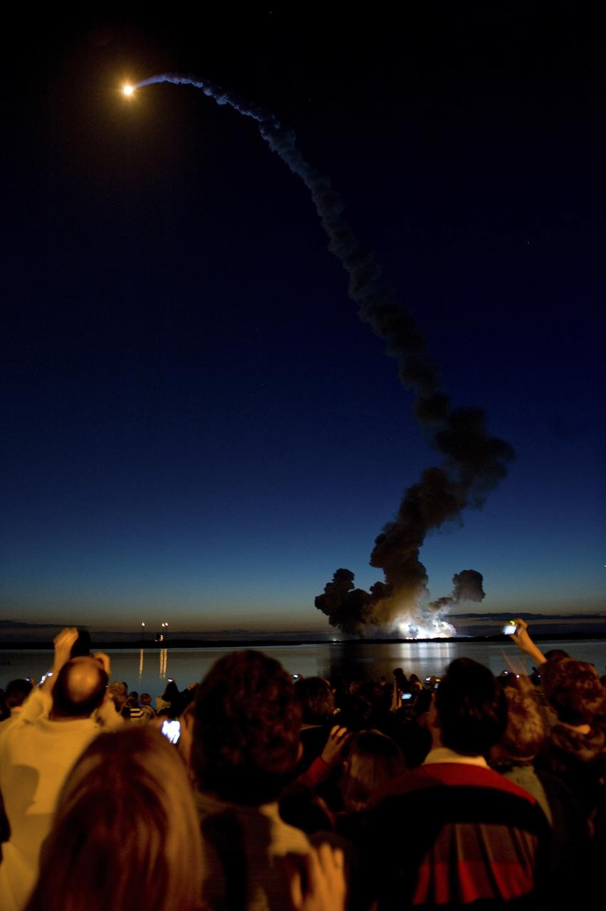 STS-131 LIFTS OFF INTO THE EARLY MORNING SKY AS SPECTATORS AT THE BANANA CREEK VIEWING AREA OBSERVE