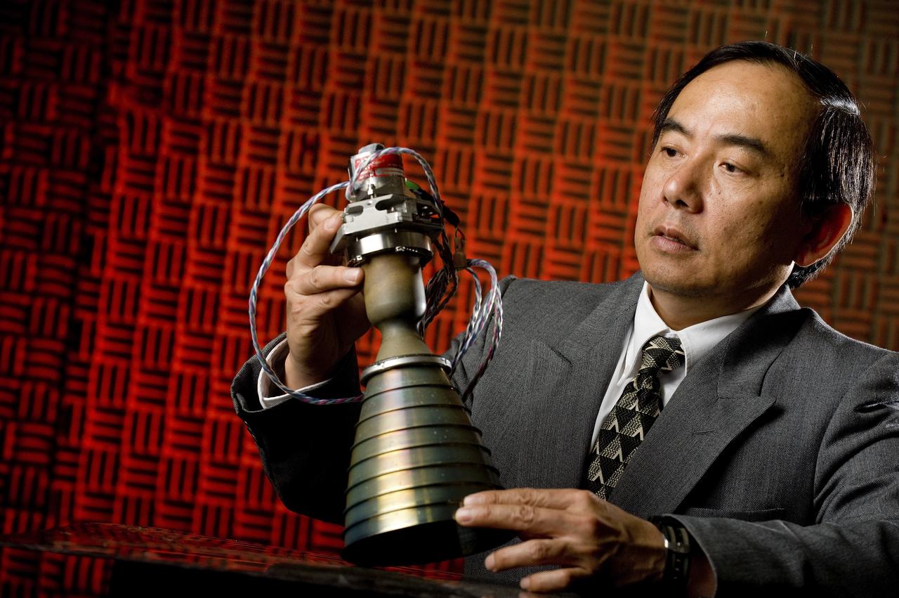 HUU TRINH POSES WITH A HYPERGOLIC BI-PROPELLANT THRUSTER FOR A POTENTIAL APPLICATION ON FUTURE ROBOTIC LUNAR SPACECRAFTS.  