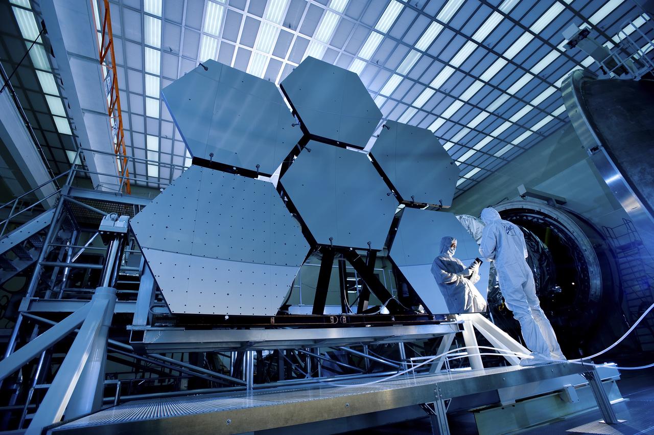 BALL AEROSPACE'S JAKE LEWIS IS REFLECTED IN ONE OF THE MIRRORS ON A JAMES WEBB SPACE TELESCOPE ARRAY THAT WAS IN THE X-RAY AND CRYOGENIC FACILITY FOR TESTING