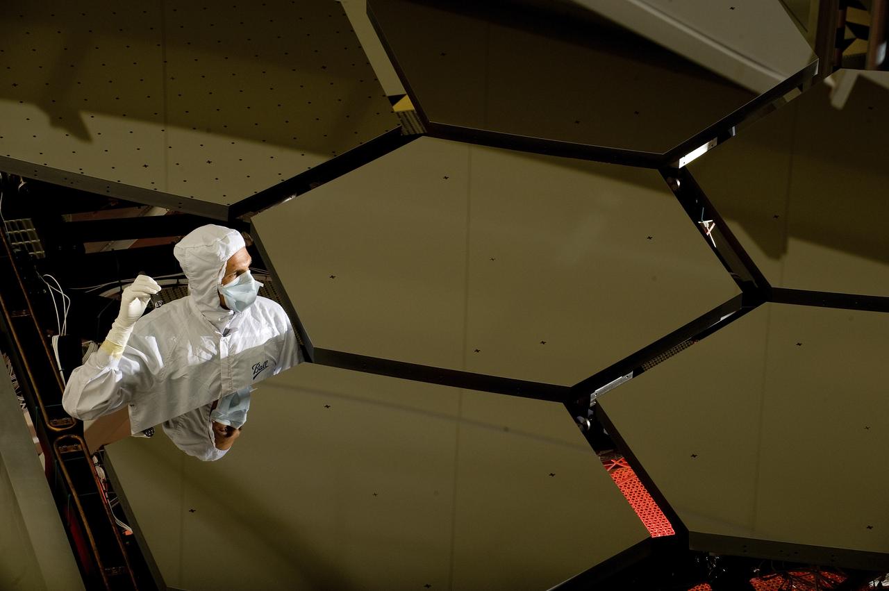 A BALL AEROSPACE TECHNICIAN STANDS WITHIN A JAMES WEBB SPACE TELESCOPE ARRAY THAT WAS IN THE X-RAY AND CRYOGENIC FACILITY FOR TESTING