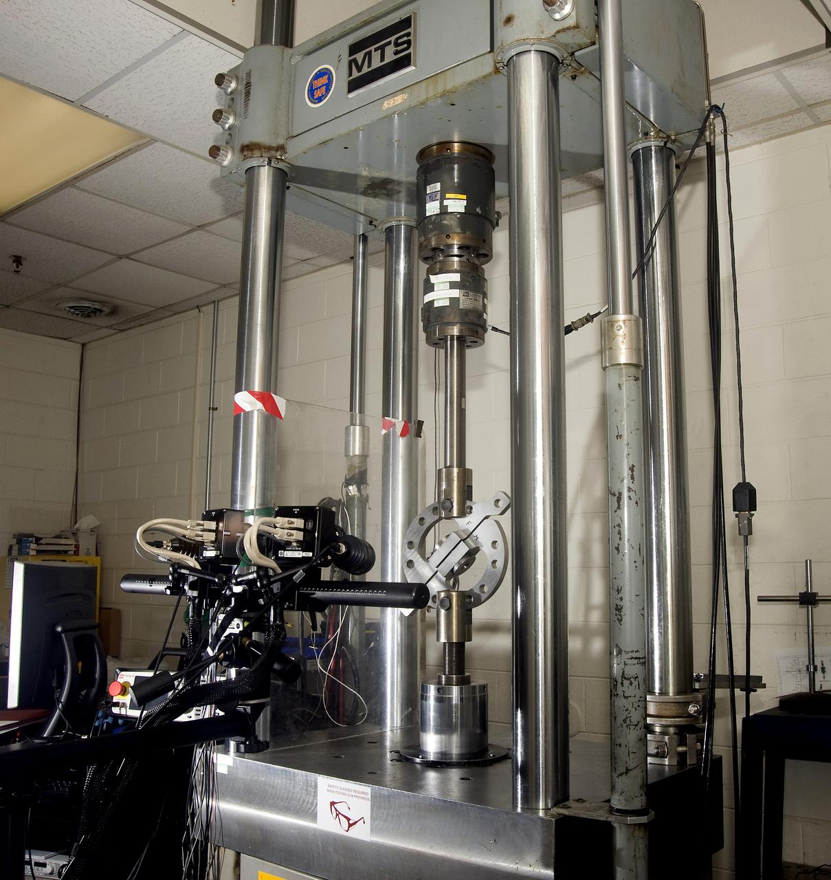 DEVELOPMENT TESTING BEING CONDUCTED AT THE REQUEST OF THE MSFC DYNAMICS, LOADS, AND STRENGTH BRANCH (EV31) TO STUDY THE FAILURE BEHAVIOR OF FASTENERS SUBJECTED TO COMBINED SHEAR AND TENSION LOADING.  THE DATA FROM THIS TESTING WILL BE USED TO DEVELOP APPROPRIATE STRUCTURAL ANALYSIS METHODS AS PART OF A FASTENER STANDARDS EFFORT SPONSORED BY THE NASA ENGINEERING SAFETY CENTER (NESC).  THE TEST FIXTURE WAS DESIGNED AND FABRICATED THROUGH THE MSFC MECHANICAL FABRICATION BRANCH (ES23).  THE TESTING ORGANIZATION IS THE MSFC MATERIALS TEST BRANCH (EM10).  