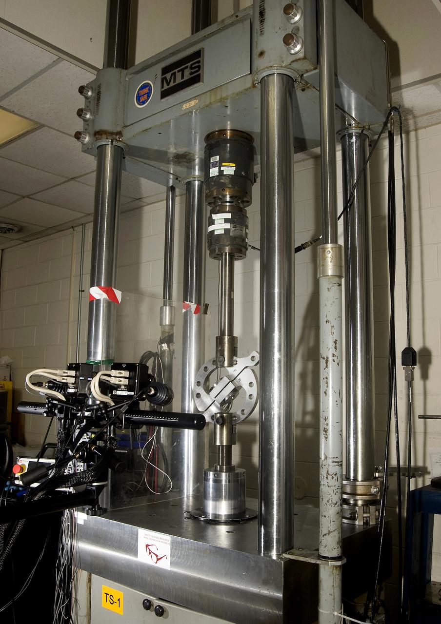 DEVELOPMENT TESTING BEING CONDUCTED AT THE REQUEST OF THE MSFC DYNAMICS, LOADS, AND STRENGTH BRANCH (EV31) TO STUDY THE FAILURE BEHAVIOR OF FASTENERS SUBJECTED TO COMBINED SHEAR AND TENSION LOADING.  THE DATA FROM THIS TESTING WILL BE USED TO DEVELOP APPROPRIATE STRUCTURAL ANALYSIS METHODS AS PART OF A FASTENER STANDARDS EFFORT SPONSORED BY THE NASA ENGINEERING SAFETY CENTER (NESC).  THE TEST FIXTURE WAS DESIGNED AND FABRICATED THROUGH THE MSFC MECHANICAL FABRICATION BRANCH (ES23).  THE TESTING ORGANIZATION IS THE MSFC MATERIALS TEST BRANCH (EM10).  