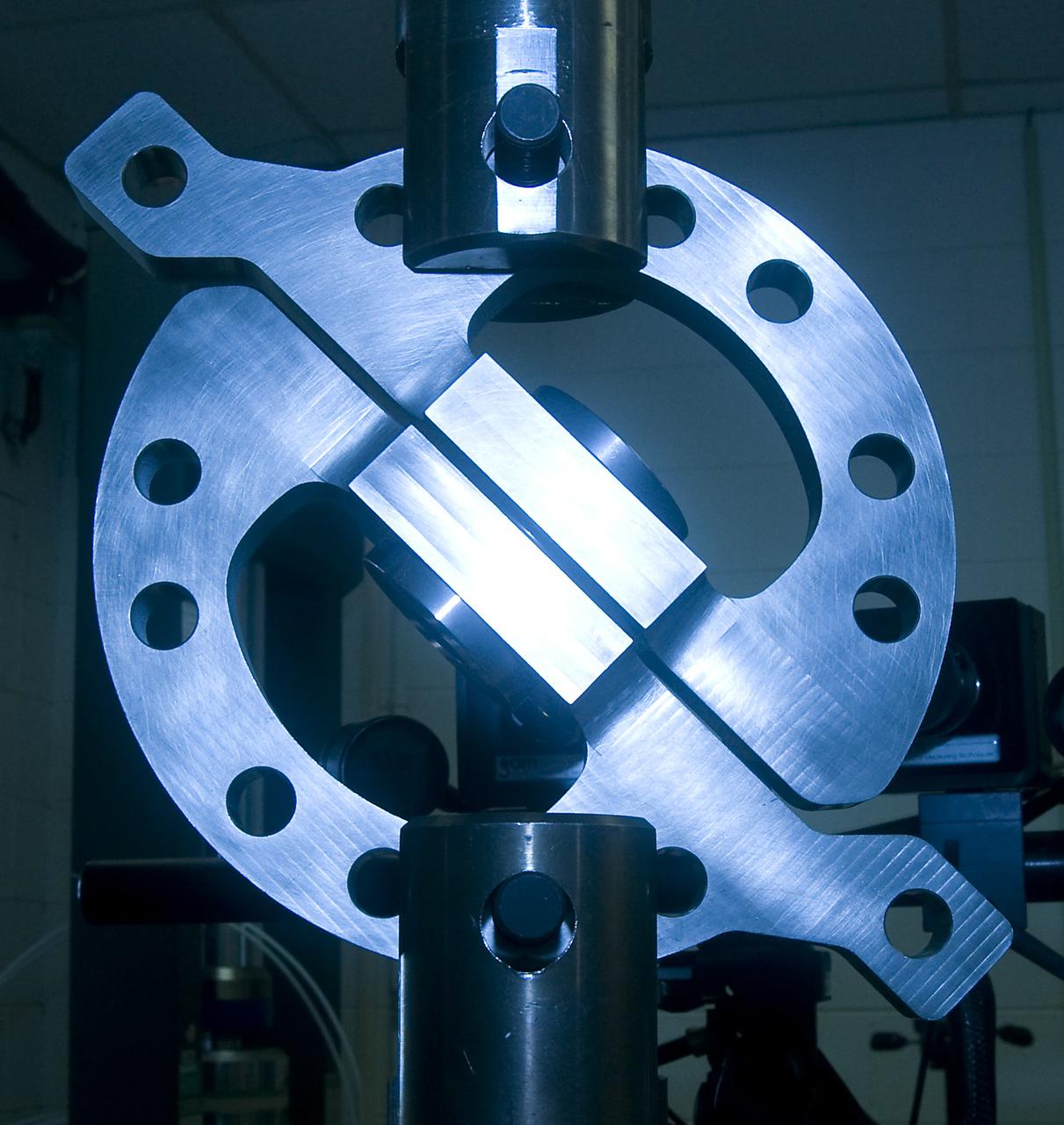 DEVELOPMENT TESTING BEING CONDUCTED AT THE REQUEST OF THE MSFC DYNAMICS, LOADS, AND STRENGTH BRANCH (EV31) TO STUDY THE FAILURE BEHAVIOR OF FASTENERS SUBJECTED TO COMBINED SHEAR AND TENSION LOADING.  THE DATA FROM THIS TESTING WILL BE USED TO DEVELOP APPROPRIATE STRUCTURAL ANALYSIS METHODS AS PART OF A FASTENER STANDARDS EFFORT SPONSORED BY THE NASA ENGINEERING SAFETY CENTER (NESC).  THE TEST FIXTURE WAS DESIGNED AND FABRICATED THROUGH THE MSFC MECHANICAL FABRICATION BRANCH (ES23).  THE TESTING ORGANIZATION IS THE MSFC MATERIALS TEST BRANCH (EM10).  