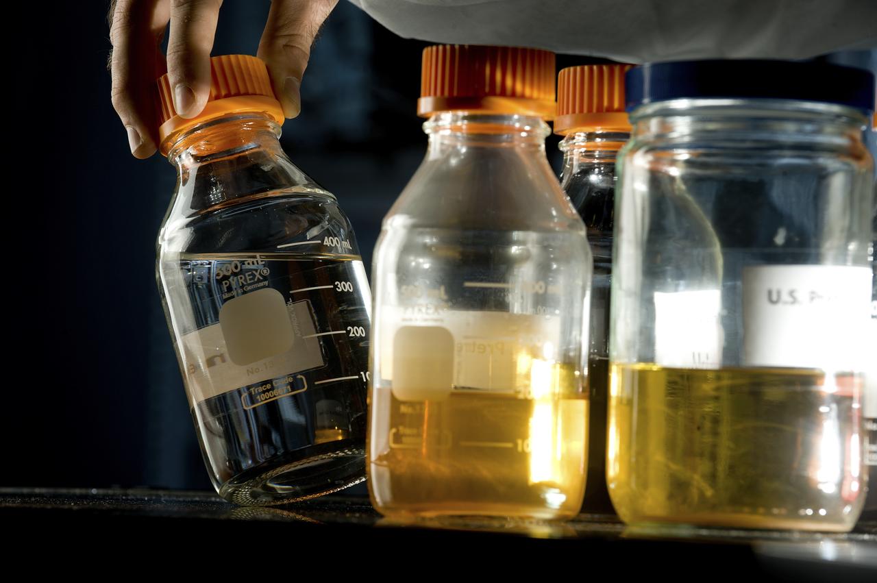 PHOTOS OF BOTTLES CONTAINING URINE, PURIFIED WATER, AND OTHER LIQUIDS AS PART OF THE STEPS OF THE ECLSS PROGRAM
