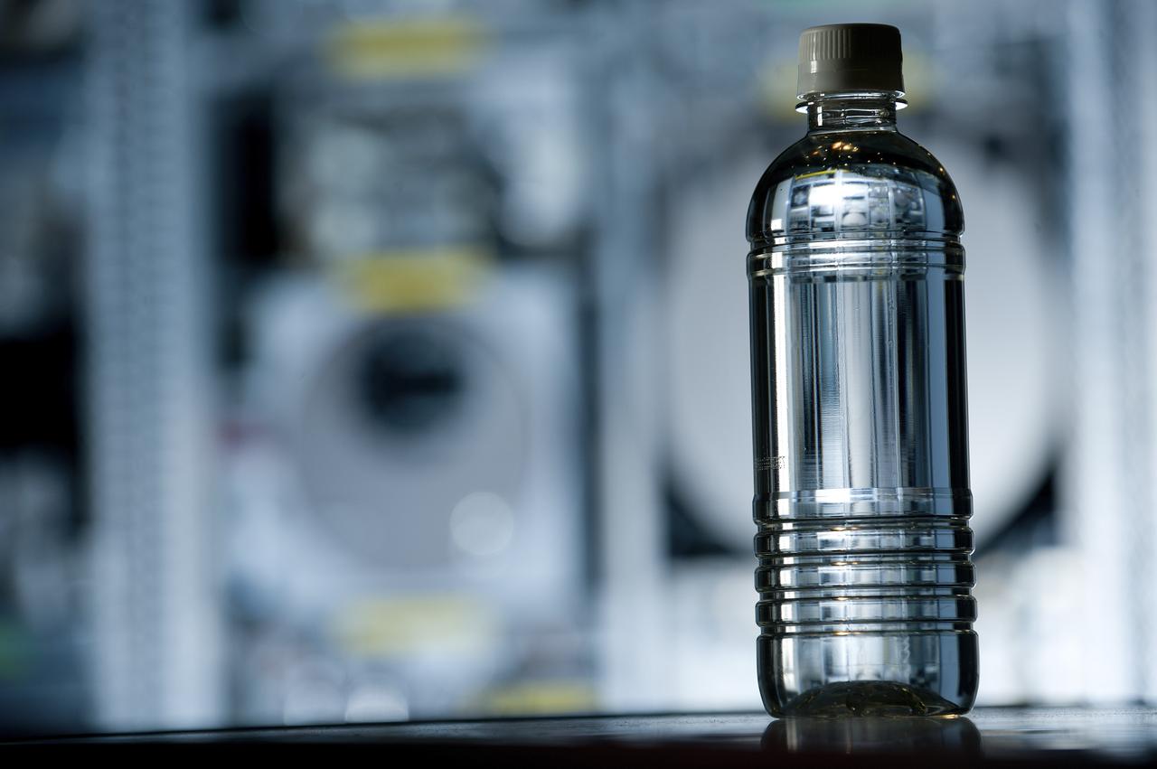 PHOTOS OF BOTTLES CONTAINING URINE, PURIFIED WATER, AND OTHER LIQUIDS AS PART OF THE STEPS OF THE ECLSS PROGRAM