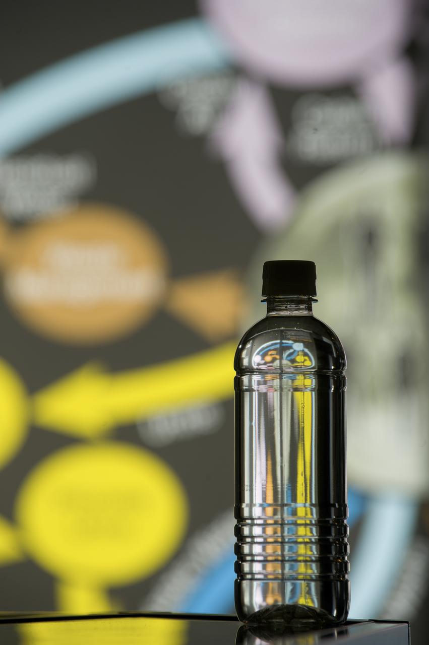 PHOTOS OF BOTTLES CONTAINING URINE, PURIFIED WATER, AND OTHER LIQUIDS AS PART OF THE STEPS OF THE ECLSS PROGRAM