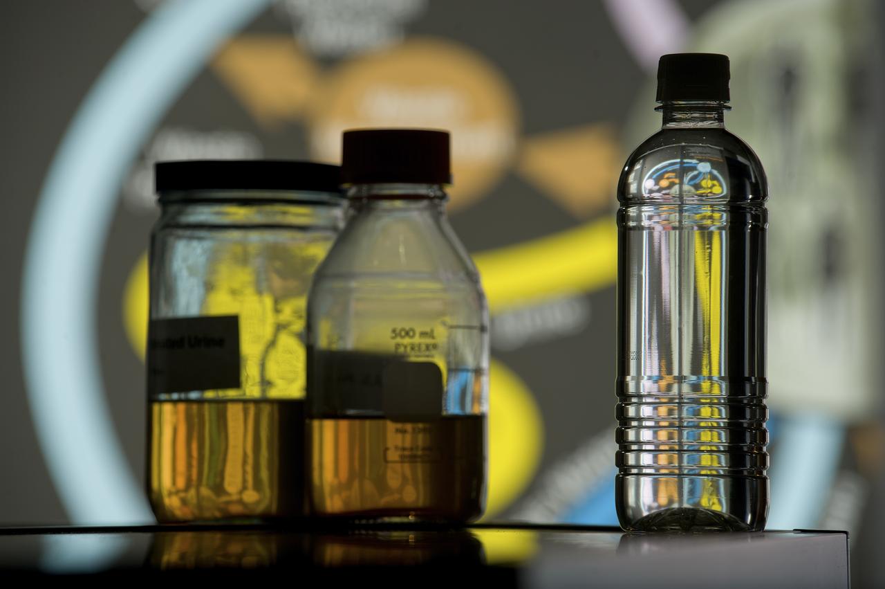 PHOTOS OF BOTTLES CONTAINING URINE, PURIFIED WATER, AND OTHER LIQUIDS AS PART OF THE STEPS OF THE ECLSS PROGRAM