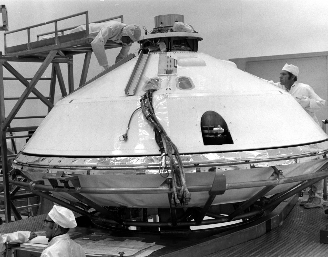 KENNEDY SPACE CENTER, FLA. --  Technicians prepared for removal of Viking Lander 1's aeroshell cover in KSC's Spacecraft Assembly and Encapsulation Facility 2 (SAEF-2) today.  The cover remains over the Lander throughout its 440,000,000-mile journey to Mars.  After the Lander separates from the Orbiter, the aeroshell will help to decelerate the speed of descent and will serve as a heat shield.  After the aeroshell separates, the Lander's parachute will deploy at about 4,000 feet altitude to further slow descent for a soft landing on the Red Planet.  The Kennedy Space Center will launch the first Viking from Complex 41, Cape Canaveral, no earlier than Aug. 11.  The second Viking will be launched no earlier than Aug. 21.