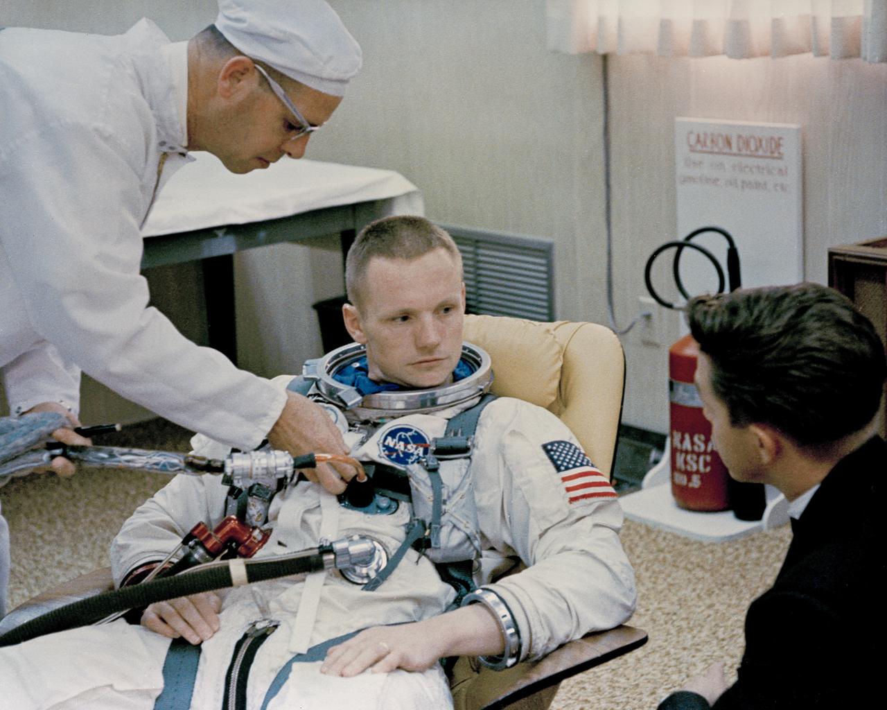 KSC-66C-1849 Gemini 8 Astronaut Neil Armstrong is aided by Suit Technician Jim Garrepy, during preparations for Gemini 8 Mission (jrs)