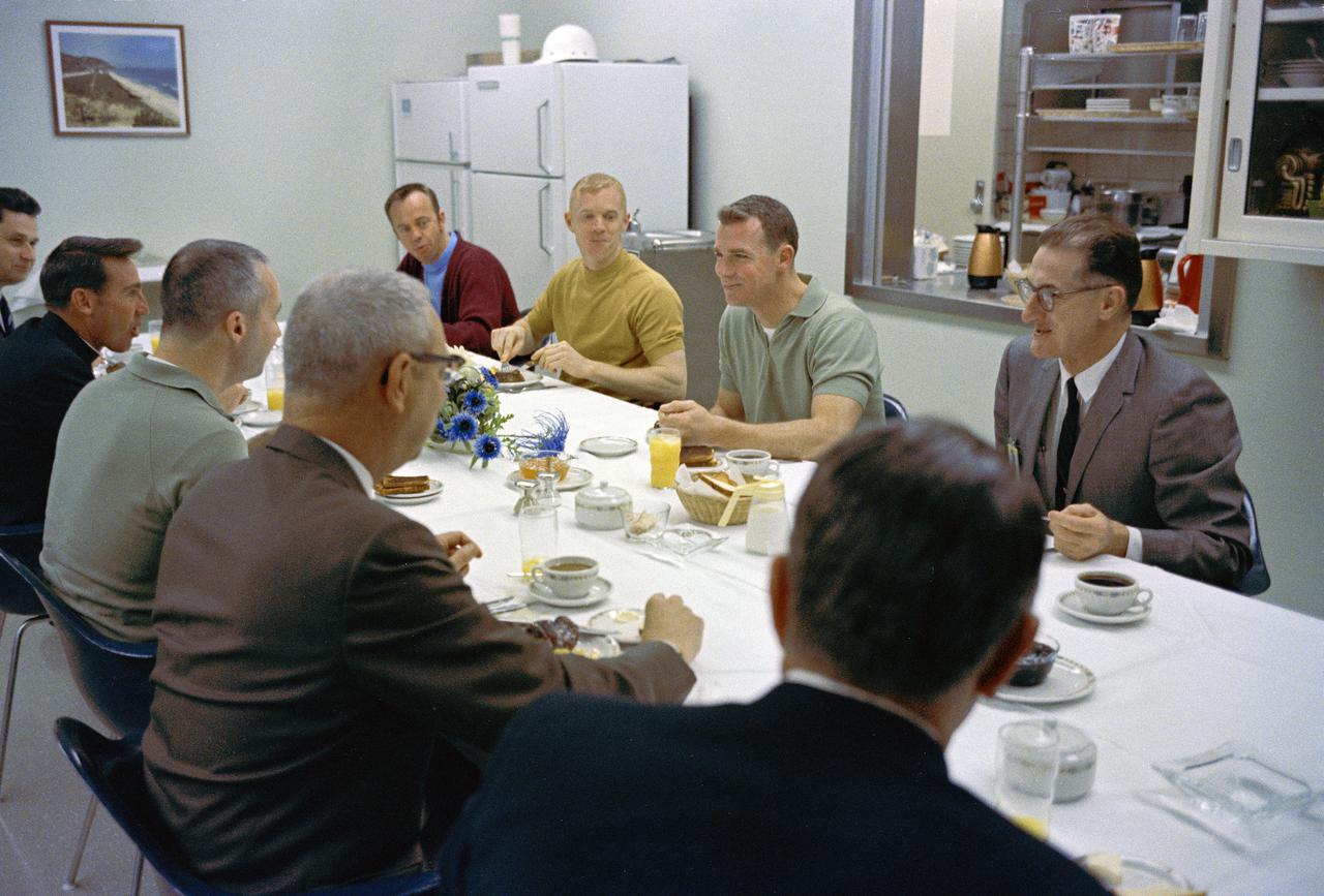 CAPE CANAVERAL, Fla. -- Apollo 9 Astronauts James A. McDivitt, David R. Scott, and Russell L. Schweickart breakfast with guests in their crew quarters of few hours before their launch into Earth orbit to test the Lunar Module spacecraft. Left to right across the table are Brig. Gen. C.H. Bolender, Scott, Schweickart, and Alan Shepard, Chief of the Astronaut Office and America's first man in space. Foreground, second from left, is Kenneth Kleinknect astronaut McDivitt his clergyman from Nassau Bay, Texas, The Rev. Laurence Connelly and George Skurla, Grumman Aircraft base manager at the spaceport. Grumman builds the Lunar Module spacecraft. Photo credit: NASA