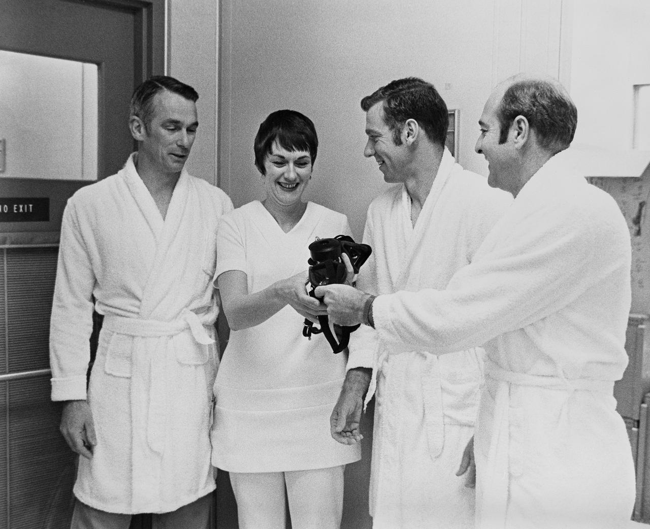 CAPE CANAVERAL, Fla. -- Apollo 14 backup crewmen, left to right, Eugene A. Cernan, Joe H. Engle and Ronald E. Evans speak with nurse Dee O’Hara prior to undergoing flight physicals today at the Kennedy Space Center. Photo credit: NASA