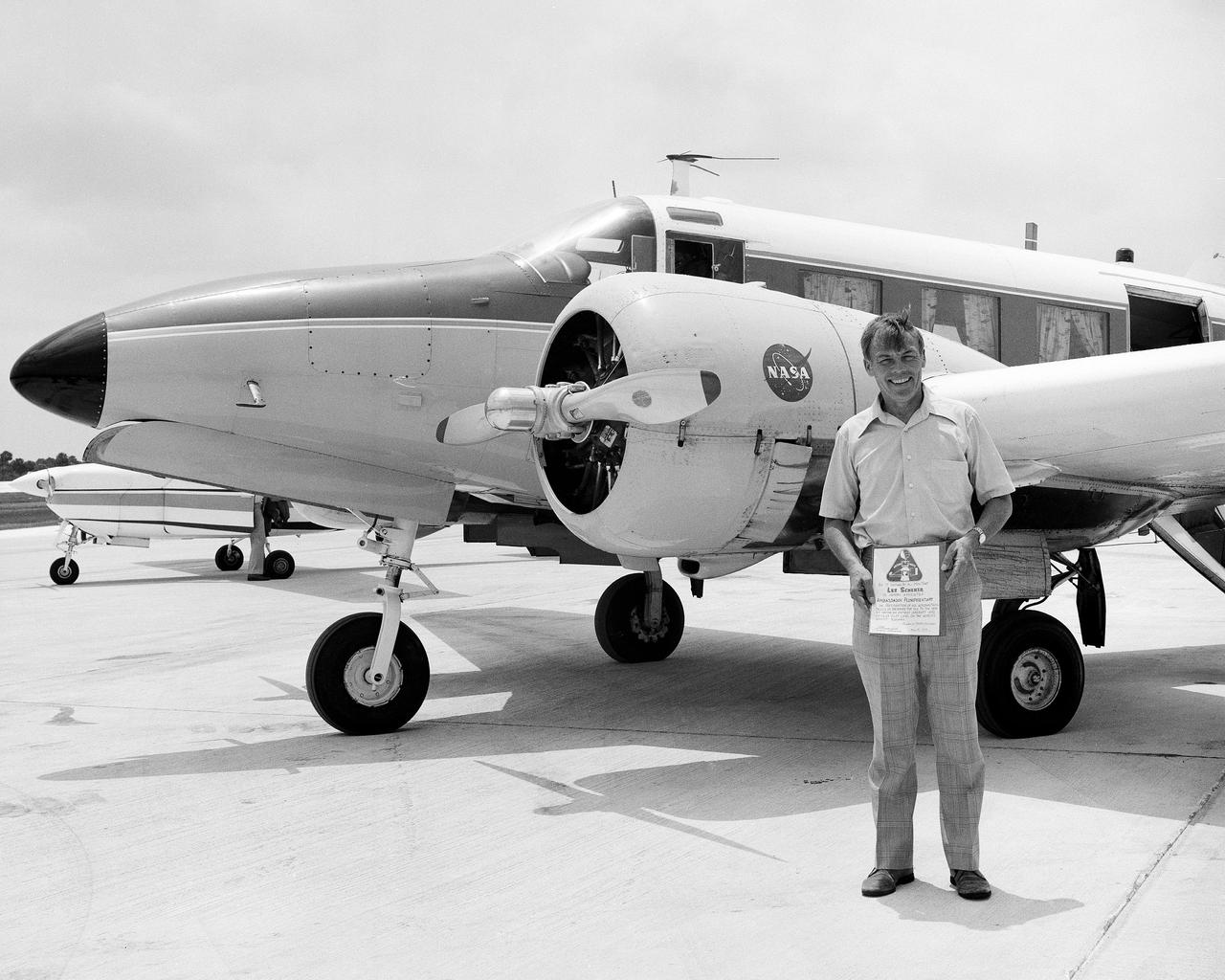 CAPE CANAVERAL, Fla. -- Kennedy Space Center Director Lee Scherer receives an Ambassador Plenipotentary certificate after successfully landing the NASA-6 aircraft on the runway at the Shuttle Landing Facility. This was the first touchdown of an aircraft on Kennedy's Shuttle Landing Facility. The certificate reads: 'Be it known that Lee Scherer is hereby appointed Ambassador Plenipotentary in recognition of his aeronautical skills in bringing the old to the new by having an antique aircraft and an antique pilot land on the world's newest runway. Photo Credit: NASA