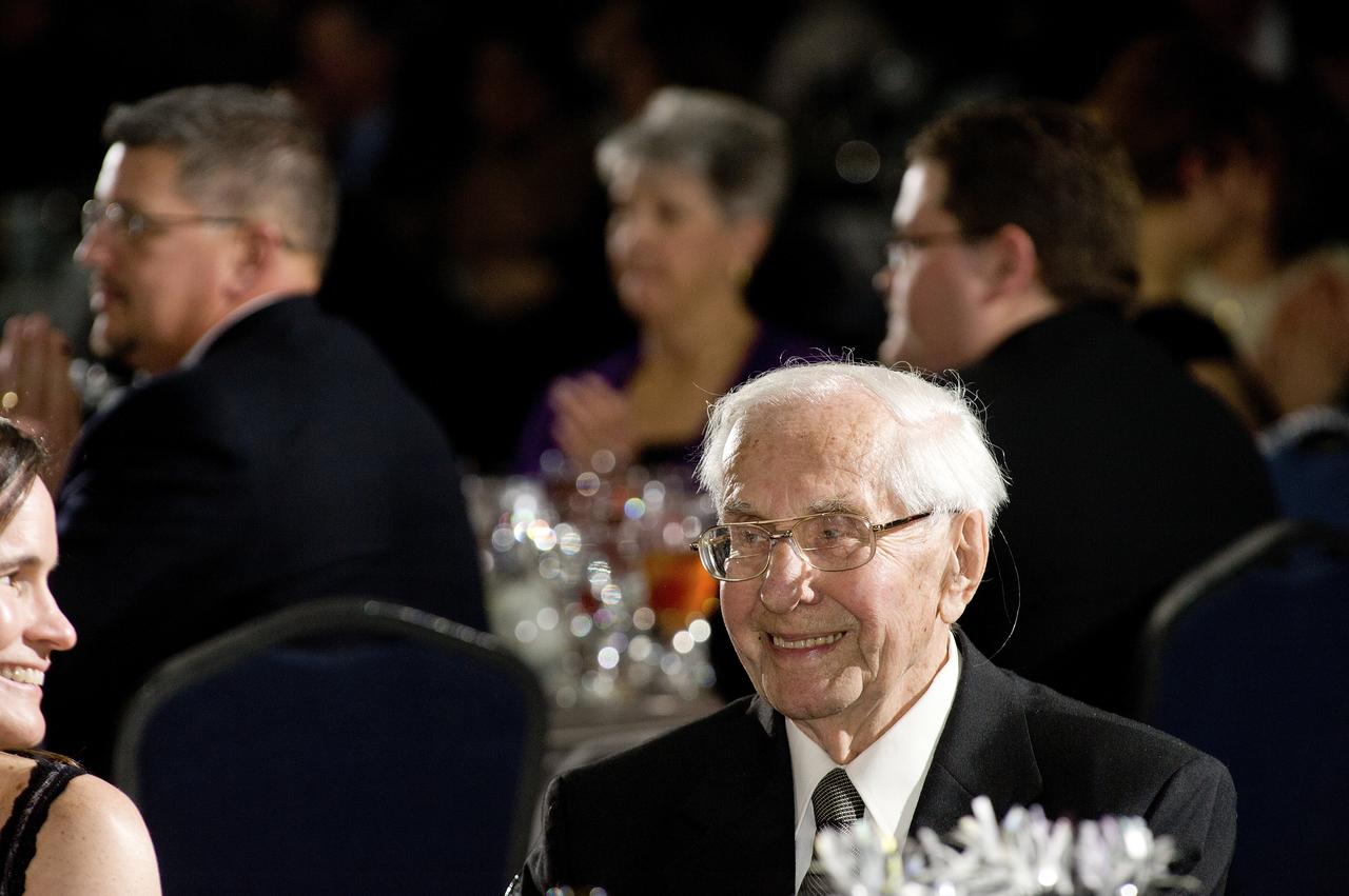 DR. GEORG (SP CORRECT) VON TIESENHAUSEN SMILES WHILE WATCHING A VIDEO PRODUCED ABOUT HIM.  
