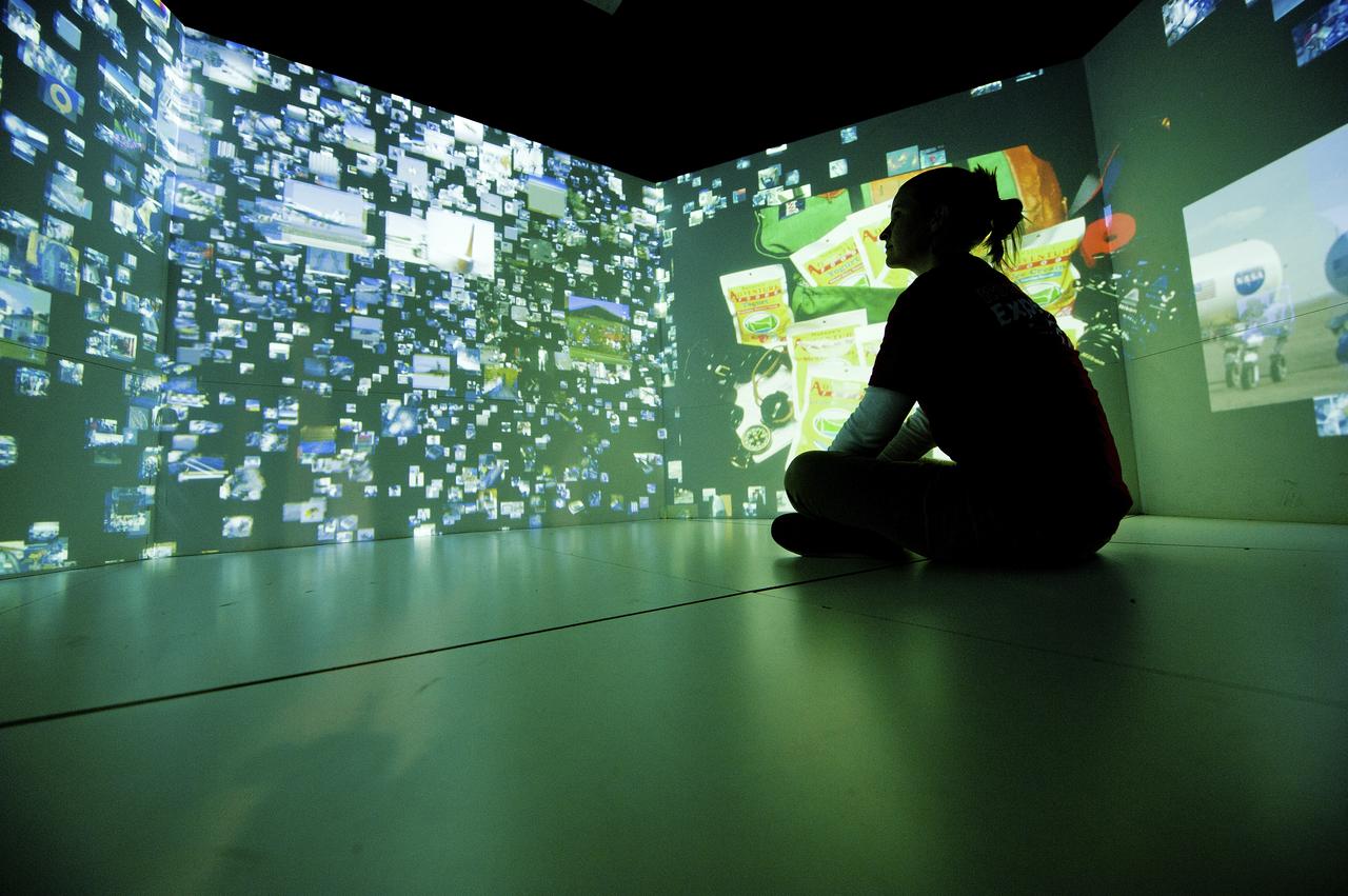 A SCI QUEST STAFFER CHECKS OUT THE INSIDE OF THE EXPLORATION EXPERIENCE PAVILION AT SCIQUEST