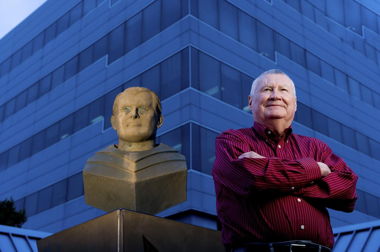 PHIL SUMRALL POSES FOR A PORTRAIT OUTSIDE OF BUILDING 4203 BESIDE OF THE VON BRAUN BUST