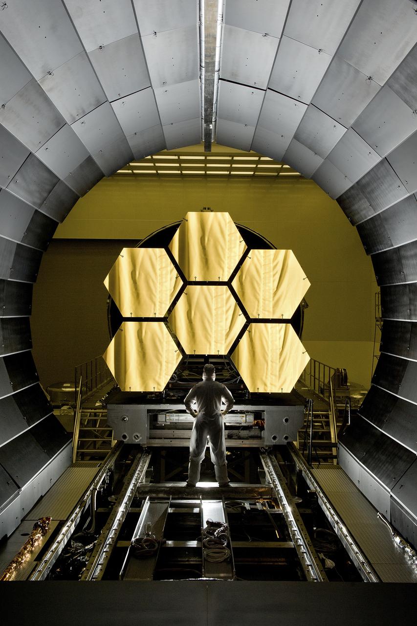 ERNIE WRIGHT STANDS NEAR THE JAMES WEBB SPACE TELESCOPE MIRRORS AS THEY SIT JUST OUTSIDE THE TESTING CHAMBER IN THE XRAY CALIBRATION FACILITY AT MSFC