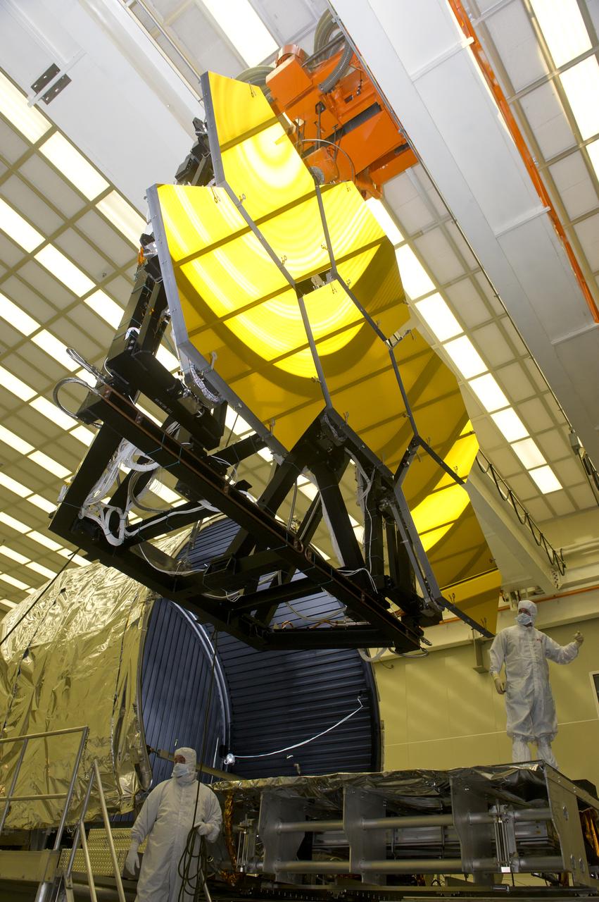 BALL AEROSPACE ENGINEER DAVE CHANEY, (L), AND MARSHALL ENGINEER HARLAN HAIGHT, (R), GUIDE ARRAY OF SIX GOLD-PLATED JAMES WEBB SPACE TELESCOPE MIRRORS AFTER FINAL ACCEPTANCE TESTING AT MARSHALL'S X-RAY AND CRYOGENIC FACILITY
