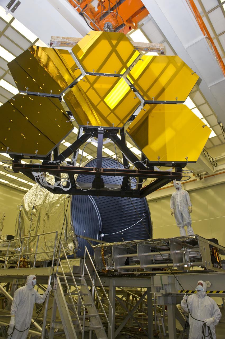 BALL AEROSPACE ENGINEER DAVE CHANEY, (L), AND MARSHALL ENGINEER HARLAN HAIGHT, (R), GUIDE ARRAY OF SIX GOLD-PLATED JAMES WEBB SPACE TELESCOPE MIRRORS AFTER FINAL ACCEPTANCE TESTING AT MARSHALL'S X-RAY AND CRYOGENIC FACILITY