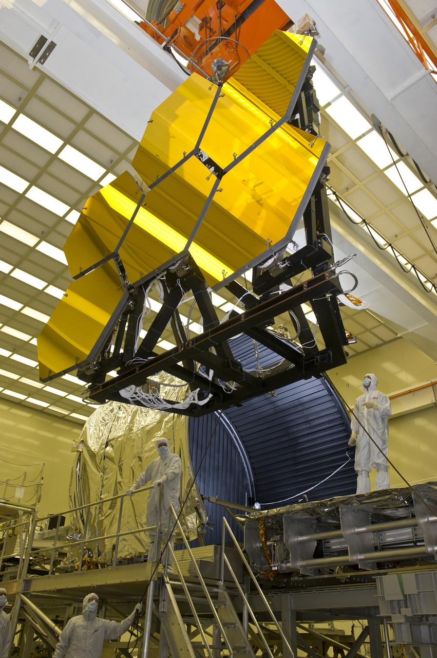 BALL AEROSPACE ENGINEER DAVE CHANEY, (L), AND MARSHALL ENGINEER HARLAN HAIGHT, (R), GUIDE ARRAY OF SIX GOLD-PLATED JAMES WEBB SPACE TELESCOPE MIRRORS AFTER FINAL ACCEPTANCE TESTING AT MARSHALL'S X-RAY AND CRYOGENIC FACILITY