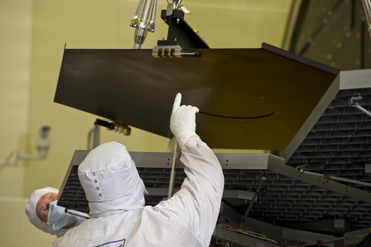 BALL ENGINEERS DISMANTLE ARRAY OF SIX GOLD-PLATED JAMES WEBB SPACE TELESCOPE MIRRORS FOR TRANSPORT TO BALL AEROSPACE AFTER CRYOGENIC TESTING AT MARSHALL'S X-RAY AND CRYOGENIC FACILITY.