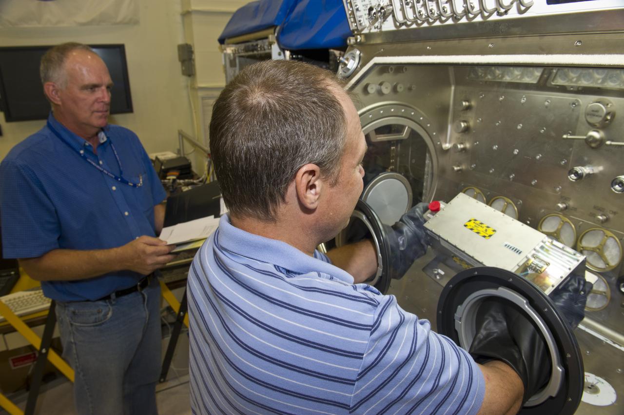 MSG TEAM MEMBERS JOHN WILSON, (L), AND PHILLIP BRYANT TEST AND INTEGRATE HARDWARE BEFORE SENDING TO ISS