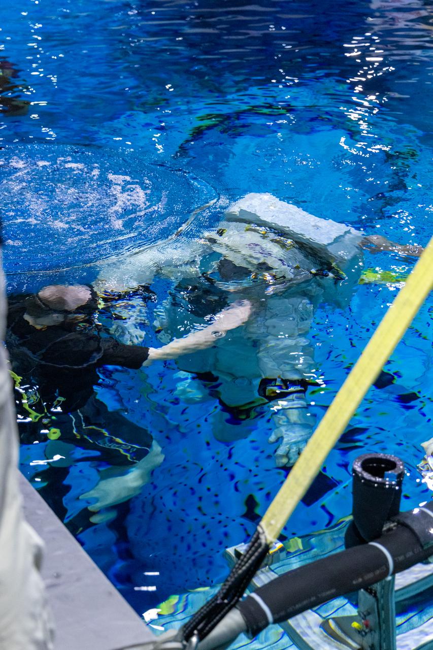 Axiom Space's AxEMU (Axiom Extravehicular Mobility Unit) spacesuit underwater during testing of its pressure garment system at NASA Johnson's Neutral Buoyancy Laboratory. Image Credit: Axiom Space