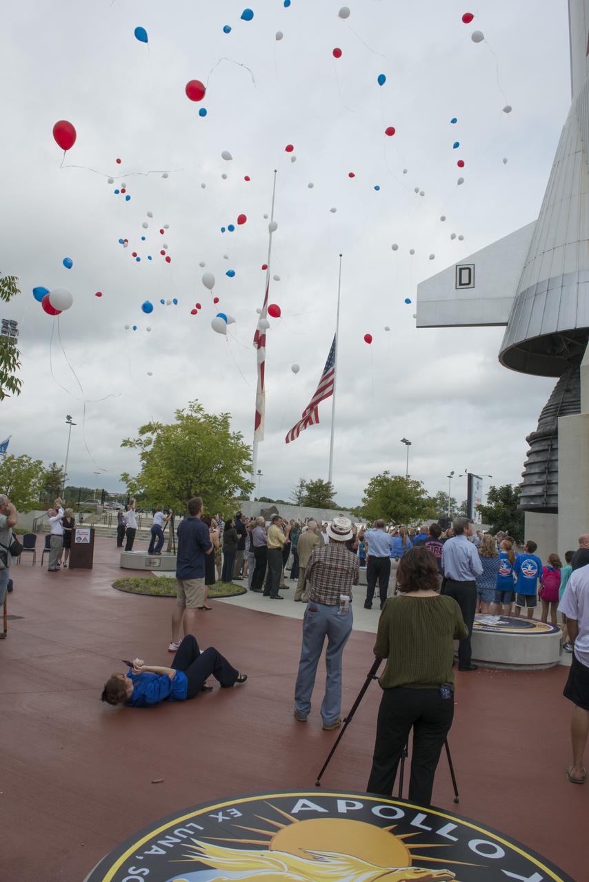 AUGUST 31, 2012 TRIBUTE TO APOLLO ASTRONAUT NEIL ARMSTRONG AT THE USSRC. A LARGE GROUP GATHERED NEAR THE LIFE-SIZE MODEL OF THE SATURN V ROCKET AND RELEASED RED, WHITE AND BLUE BALLOONS TO CELEBRATE THE LIFE OF NEIL ARMSTRONG. IN HONOR OF ARMSTRONG, FLAGS FLEW AT HALF-MAST ACROSS AMERICA ON AUGUST 31.1200934