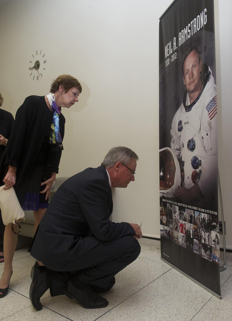 JAMES HANSEN  AND HIS WIFE MARGARET INSPECT PHOTOS ON DISPLAY OF  NEIL ARMSTRONG PRIOR TO HANSEN’S PRESENTATION TO MSFC EMPLOYEES ABOUT THE LIFE OF ARMSTRONG IN MORRIS AUDITORIUM