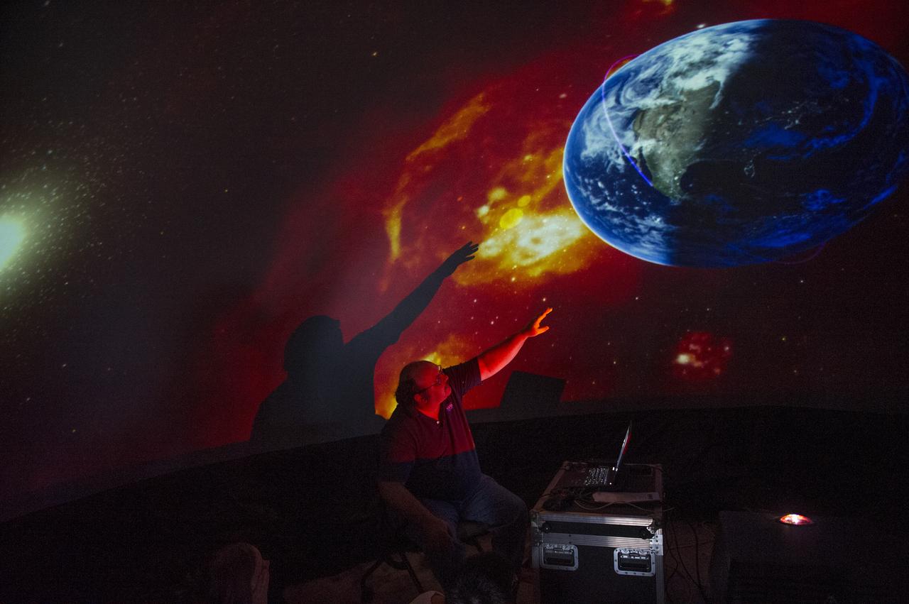 DR. BILL COOKE, LEAD OF MARSHALL'S METEOROID ENVIRONMENTS OFFICE, TOOK VISITORS ON A TOUR OF THE SOLAR SYSTEM IN ONE OF TWO INFLATABLE PLANETARIUMS FEATURED AT THE INTERNATIONAL OBSERVE THE MOON NIGHT AT NASA'S EDUCATION TRAINING FACILITY ON 9/22/12.