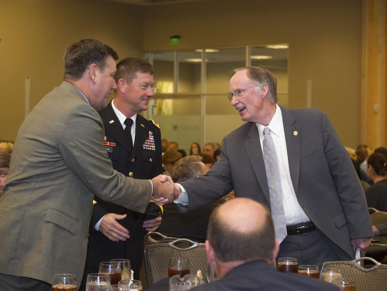 ALABAMA GOV. ROBERT BENTLEY, RIGHT, CONGRATULATES MARSHALL CENTER DIRECTOR PATRICK SCHEUERMANN, LEFT, AND U.S. ARMY MAJ. GEN. LYNN COLLYAR, COMMANDING GENERAL OF THE U.S. ARMY AVIATION & MISSILE COMMAND, FOR A SUCCESSFUL 50 YEARS OF MISSION SUCCESS AND COLLABORATION IN THE HUNTSVILLE COMMUNITY