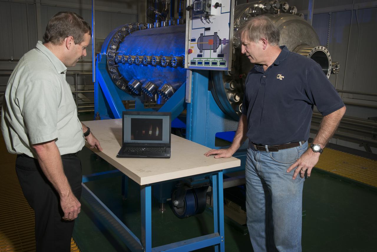 MIKE HOUTS AND BILL EMRICH DISCUSSING NUCLEAR THERMAL ROCKET ELEMENT ENVIRONMENTAL SIMULATOR (NTREES) IN BUILDING 4205. MIKE HOUTS IS THE PROJECT MANAGER.
