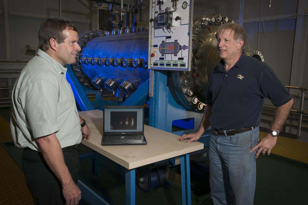 MIKE HOUTS AND BILL EMRICH DISCUSSING NUCLEAR THERMAL ROCKET ELEMENT ENVIRONMENTAL SIMULATOR (NTREES) IN BUILDING 4205. MIKE HOUTS IS THE PROJECT MANAGER.