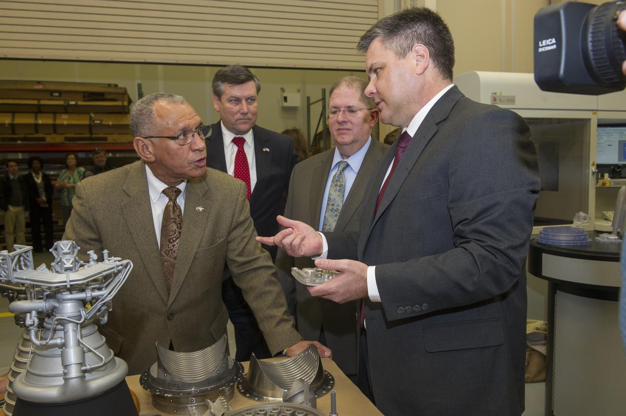 FROM LEFT, NASA ADMINISTRATOR CHARLES BOLDEN IS JOINED BY PATRICK SCHEUERMANN, NASA MARSHALL SPACE FLIGHT CENTER DIRECTOR; FRANK LEDBETTER, CHIEF OF NONMETALLIC MATERIALS AND MANUFACTURING DIVISION AT THE MARSHALL CENTER; AND ANDY HARDIN, NASA'S SPACE LAUNCH SYSTEM SUBSYSTEM MANAGER FOR LIQUID ENGINES DURING BOLDEN'S TOUR OF THE NATIONAL CENTER FOR ADVANCED MANUFACTURING RAPID PROTOTYPING FACILITY AT THE MARSHALL CENTER ON FRIDAY, FEB. 22.