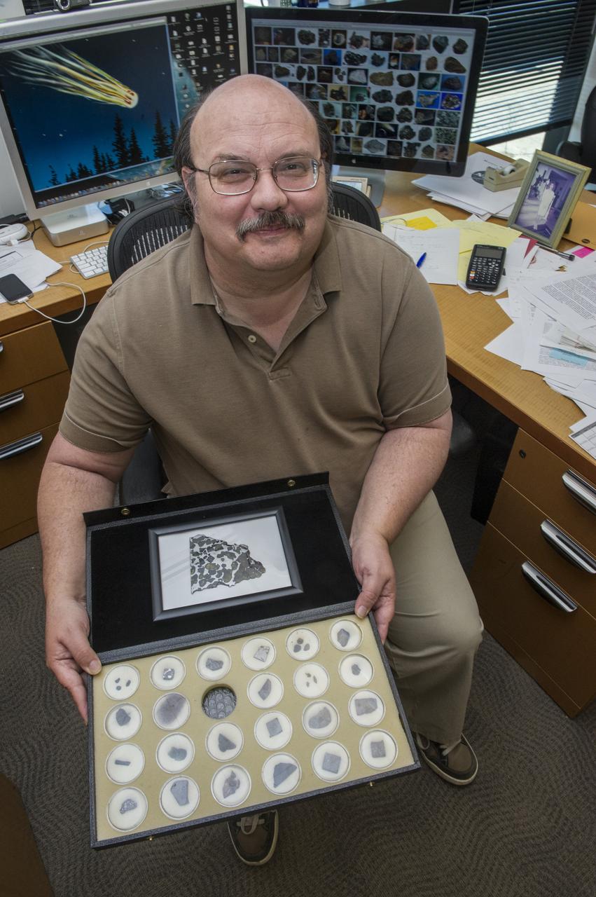 DR. BILL COOKE, LEAD OF THE METEROID ENVIRONMENT OFFICE AT MARSHALL SHOWS VARIOUS METEORITES IN HIS COLLECTION.